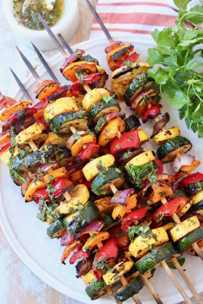 grilled vegetables on skewers on white plate