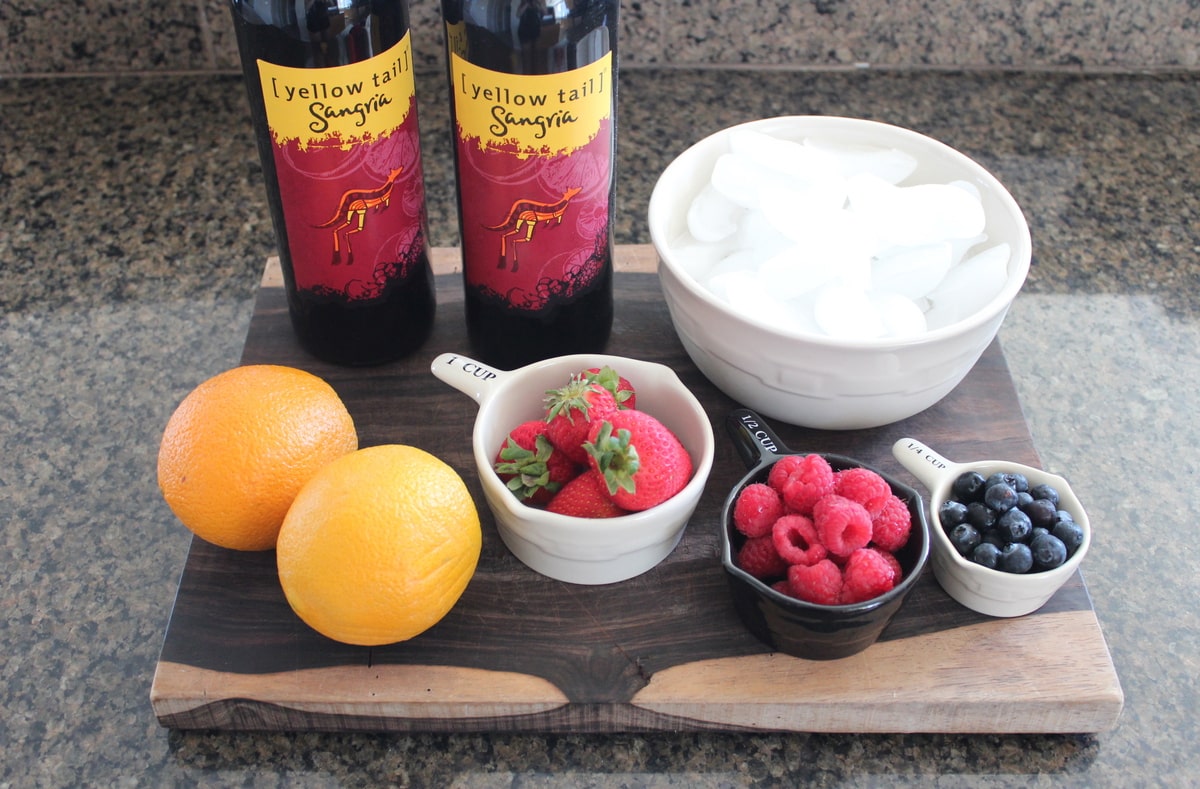 Frozen Sangria Ingredients on a wood board on a kitchen coutertop