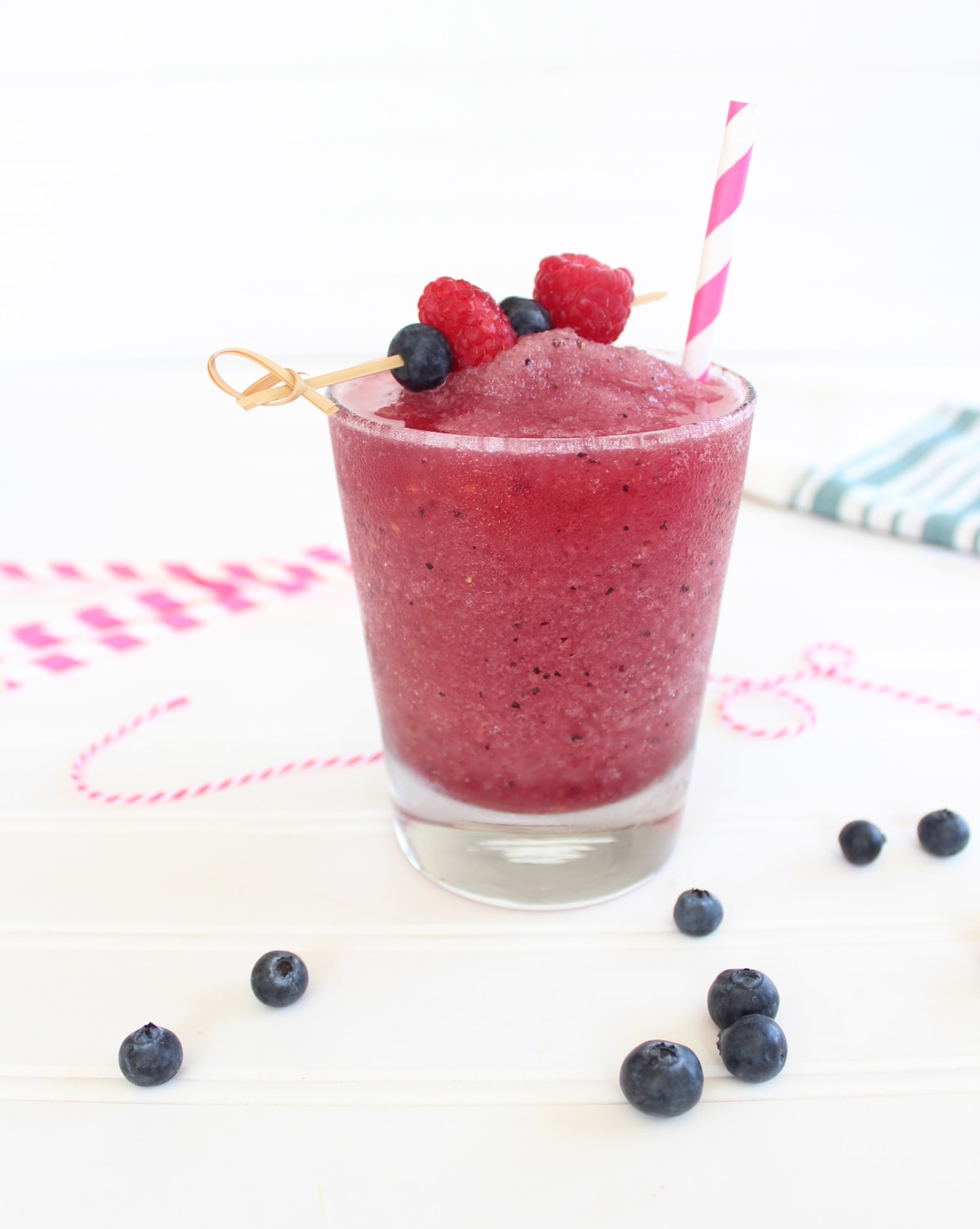 Frozen Fruit Sangria in a glass topped with a skewer of fresh fruit