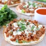 Grilled tortilla topped with buffalo sauce ground turkey and blue cheese