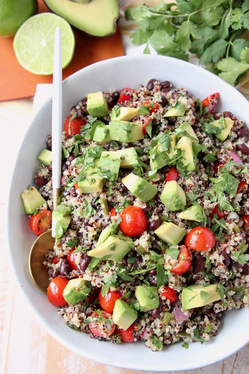 Overhead shot of quinoa salad in bowl with diced tomatoes and avocado