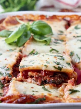 slice of vegetable lasagna being lifted out of casserole dish