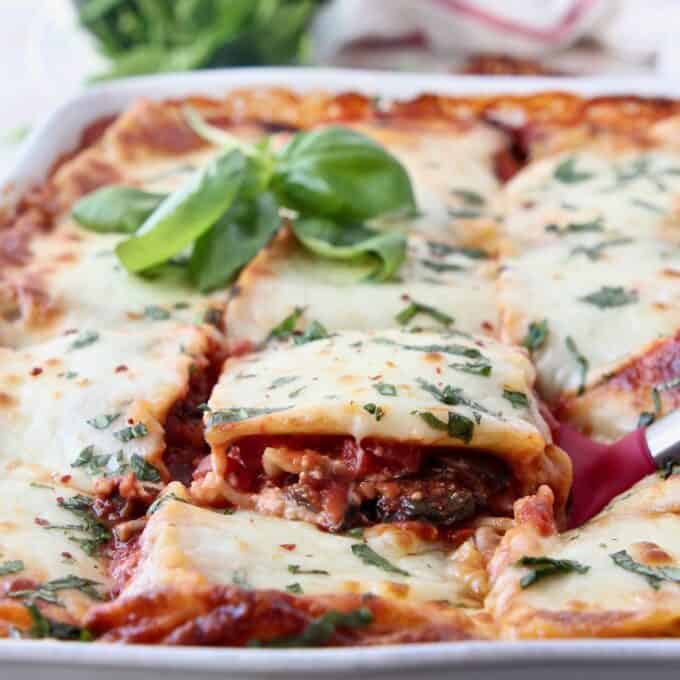 slice of vegetable lasagna being lifted out of casserole dish