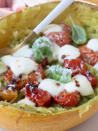 roasted spaghetti squash filled with roasted tomatoes and melted mozzarella cheese