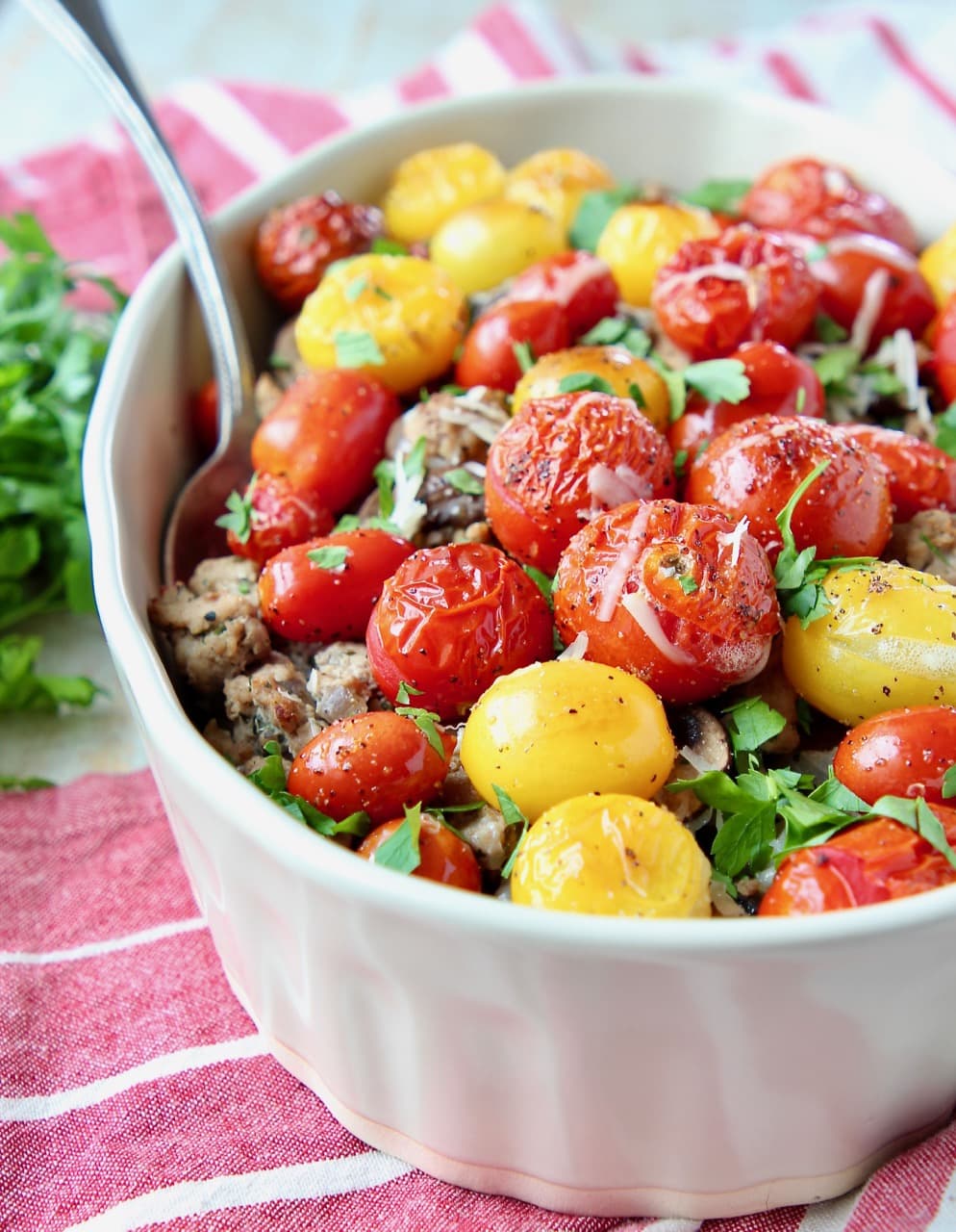 Ground turkey casserole topped with heirloom cherry tomatoes and chopped fresh parsley