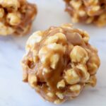 peanut butter popcorn balls on white marble serving tray