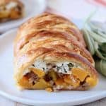 Puff pastry strudel cut open, filled with cubes of butternut squash and ricotta cheese