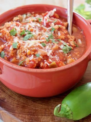 Chili in orange bowl with spoon