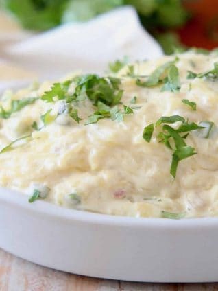 Roasted spaghetti squash tossed in a cheese sauce in a white baking dish