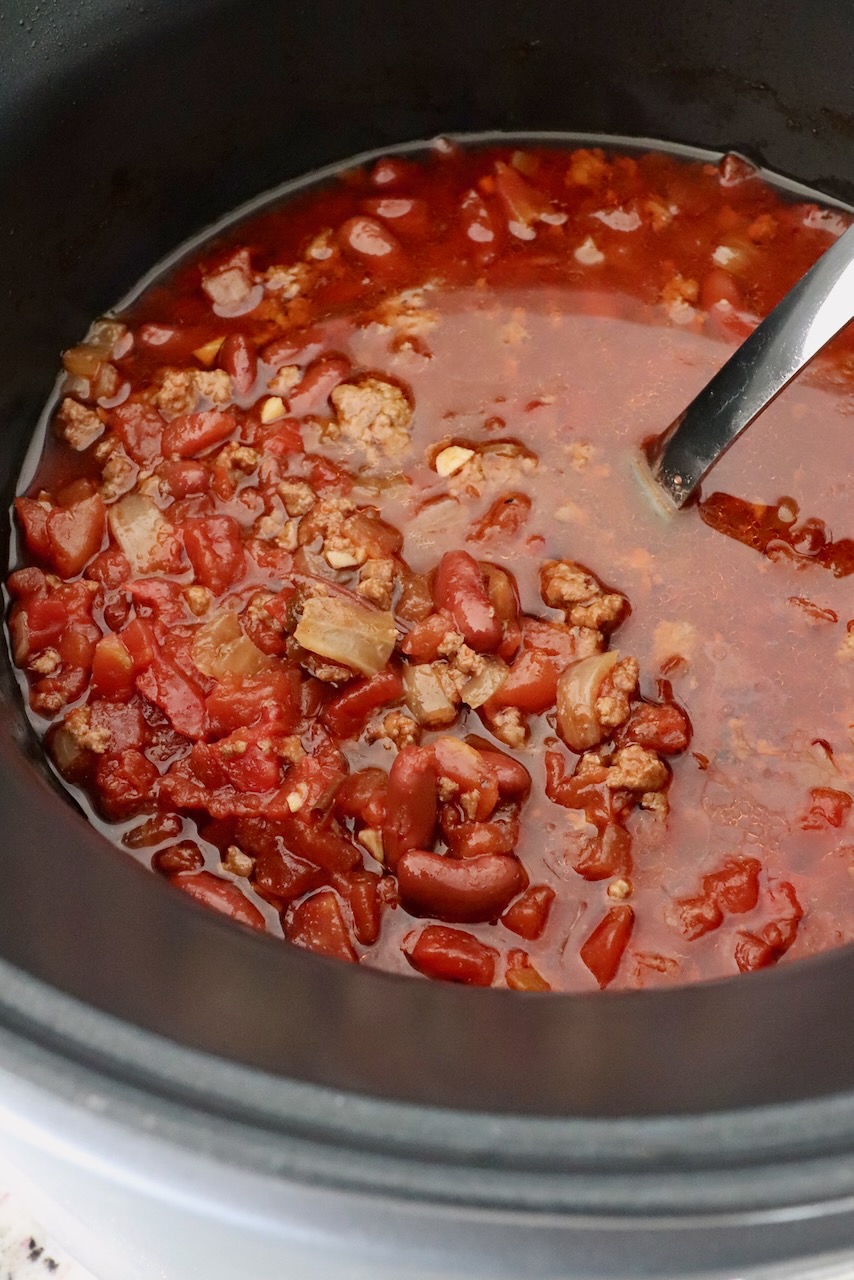 chili in a large pot with a serving spoon