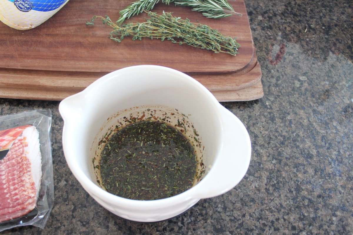 balsamic vinegar, olive oil and herbs in a bowl