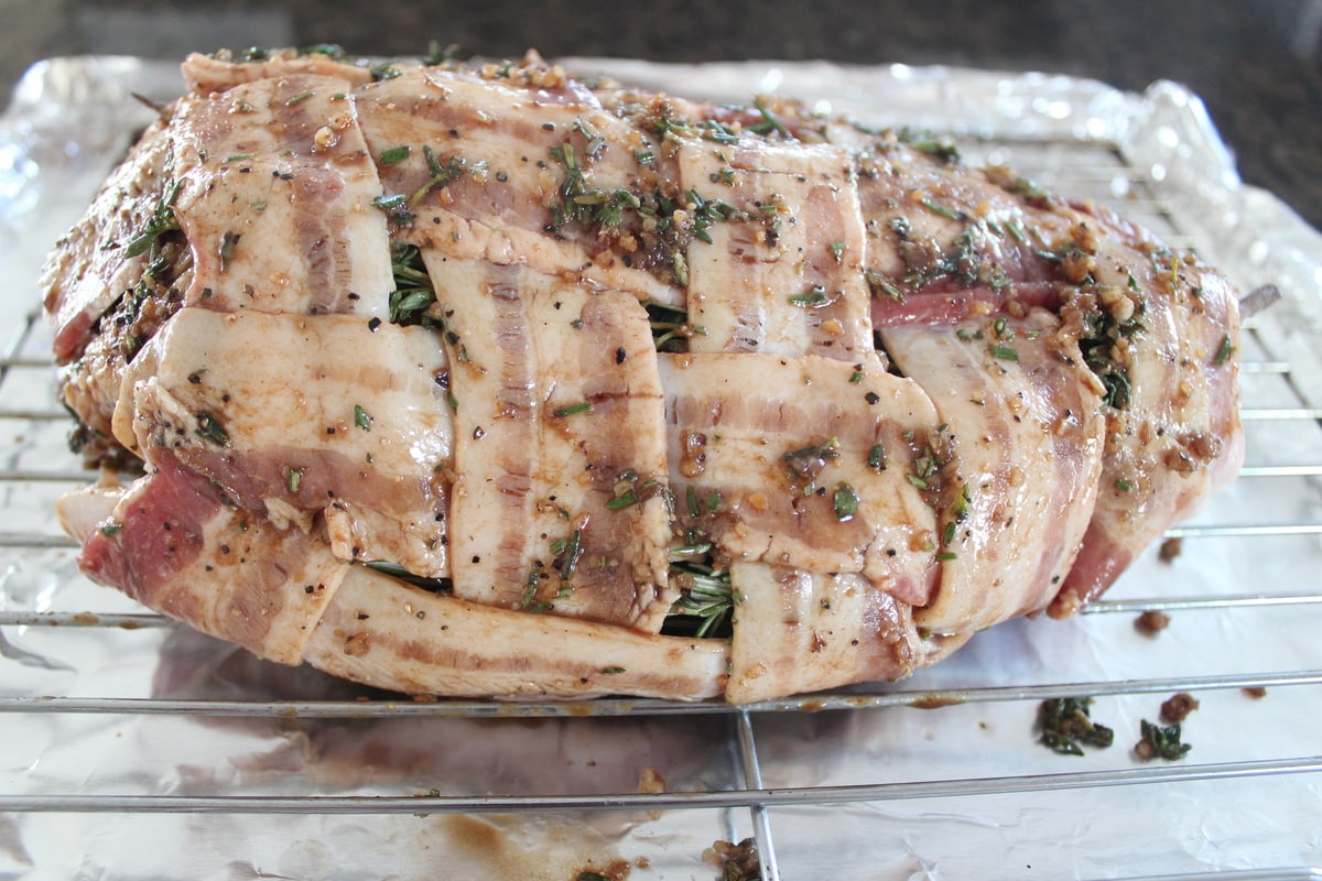 herb rubbed bacon wrapped turkey breast on wire rack
