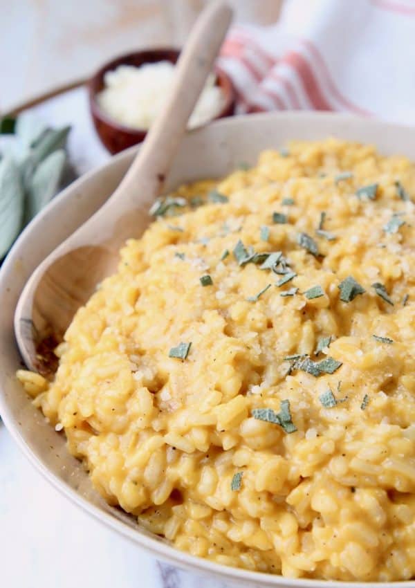 Butternut squash risotto in bowl with wooden spoon