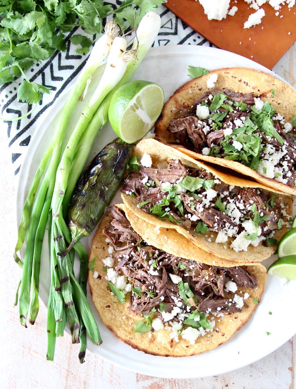 Slow Cooker Shredded Beef Barbacoa Tacos in Corn Tortillas with Grilled Green Onions, Jalapeno and Lime