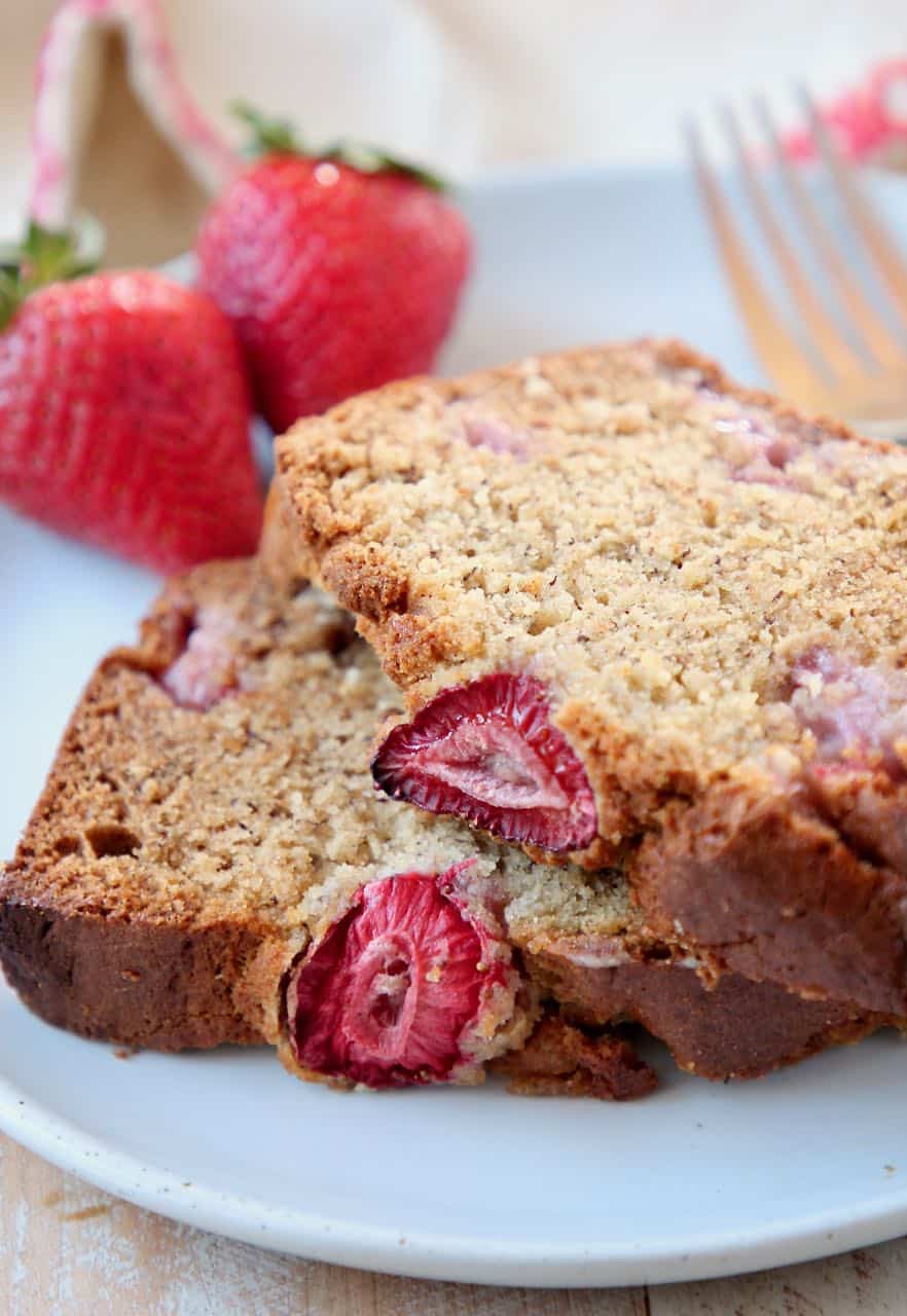 Slices of strawberry banana bread on top of each other on plate