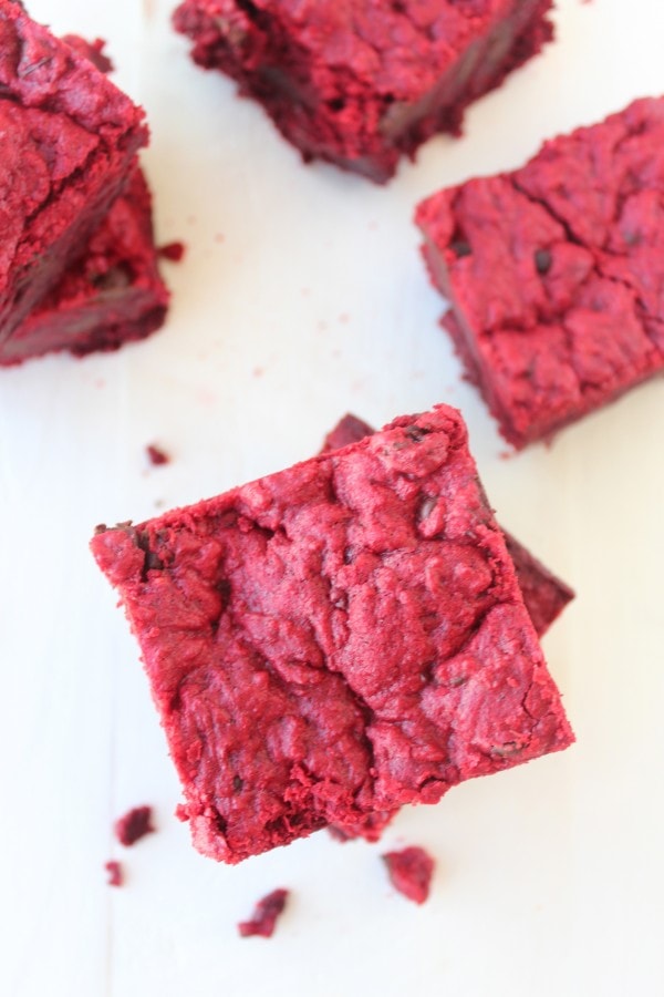 Red Velvet Brookies stacked on top of each other on a white surface. 