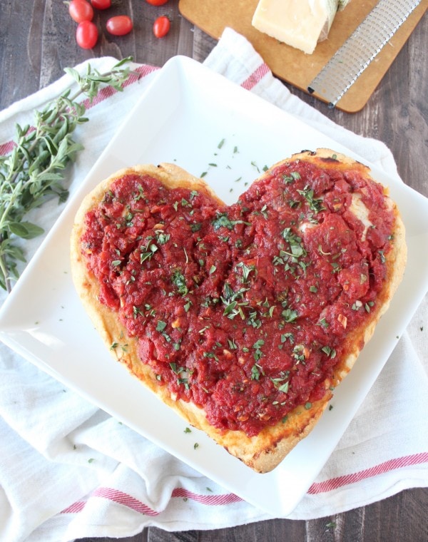 Heart Shaped Pizza on a white plate.