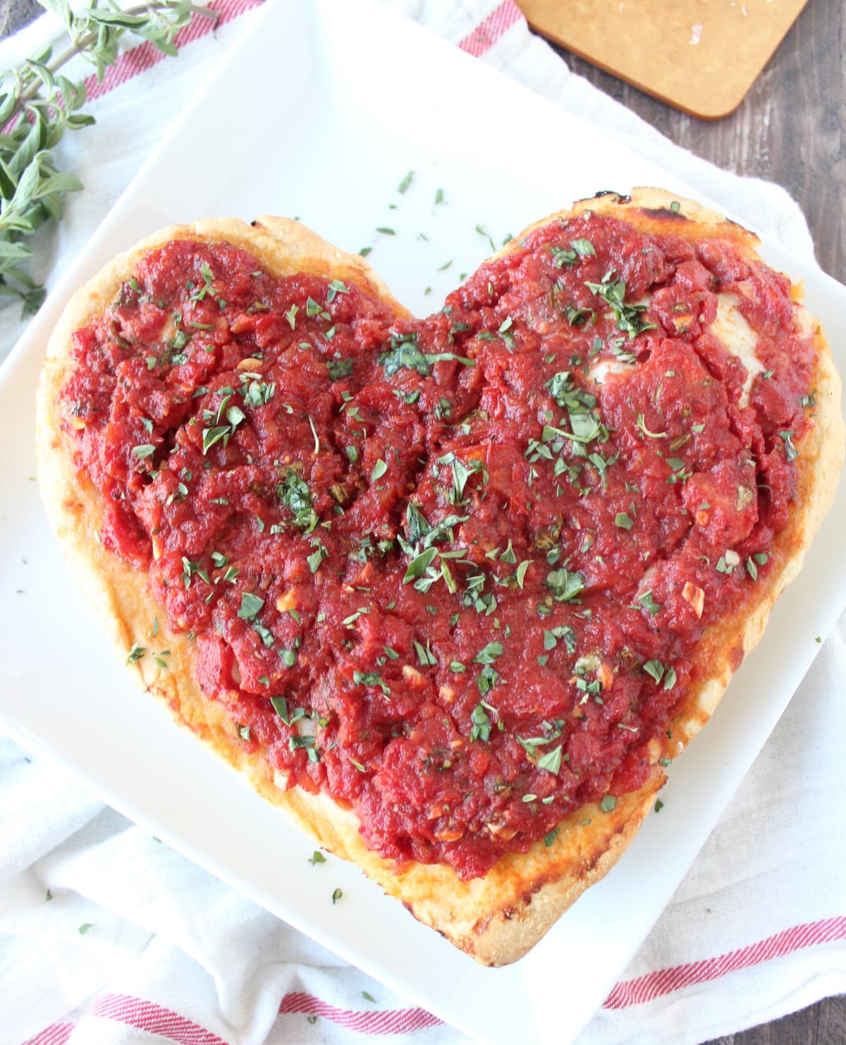 Deep Dish Heart Shaped Pizza on a white plate.