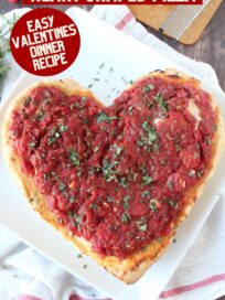 heart shaped pizza on a white plate