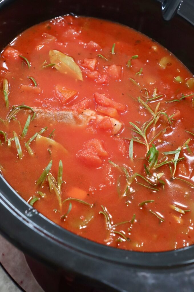 uncooked pork ragu sauce in crock pot
