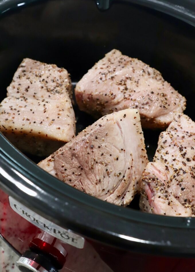 seared pork shoulder pieces in Crock Pot