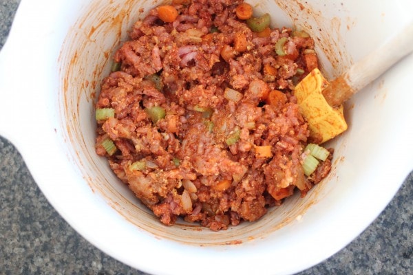 buffalo chicken meatloaf mixture in large mixing bowl with spatula