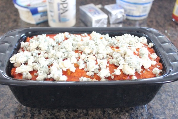 Blue Cheese Buffalo Chicken & Pork Meatloaf topped with blue cheese crumbles in a loaf pan.