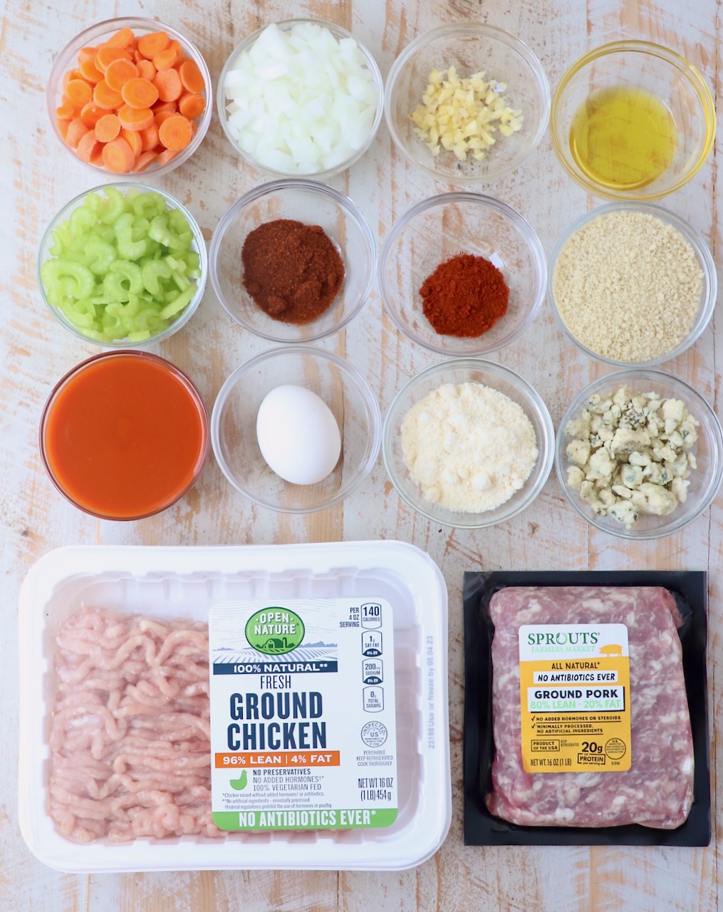 ingredients for buffalo chicken meatloaf on white wood board
