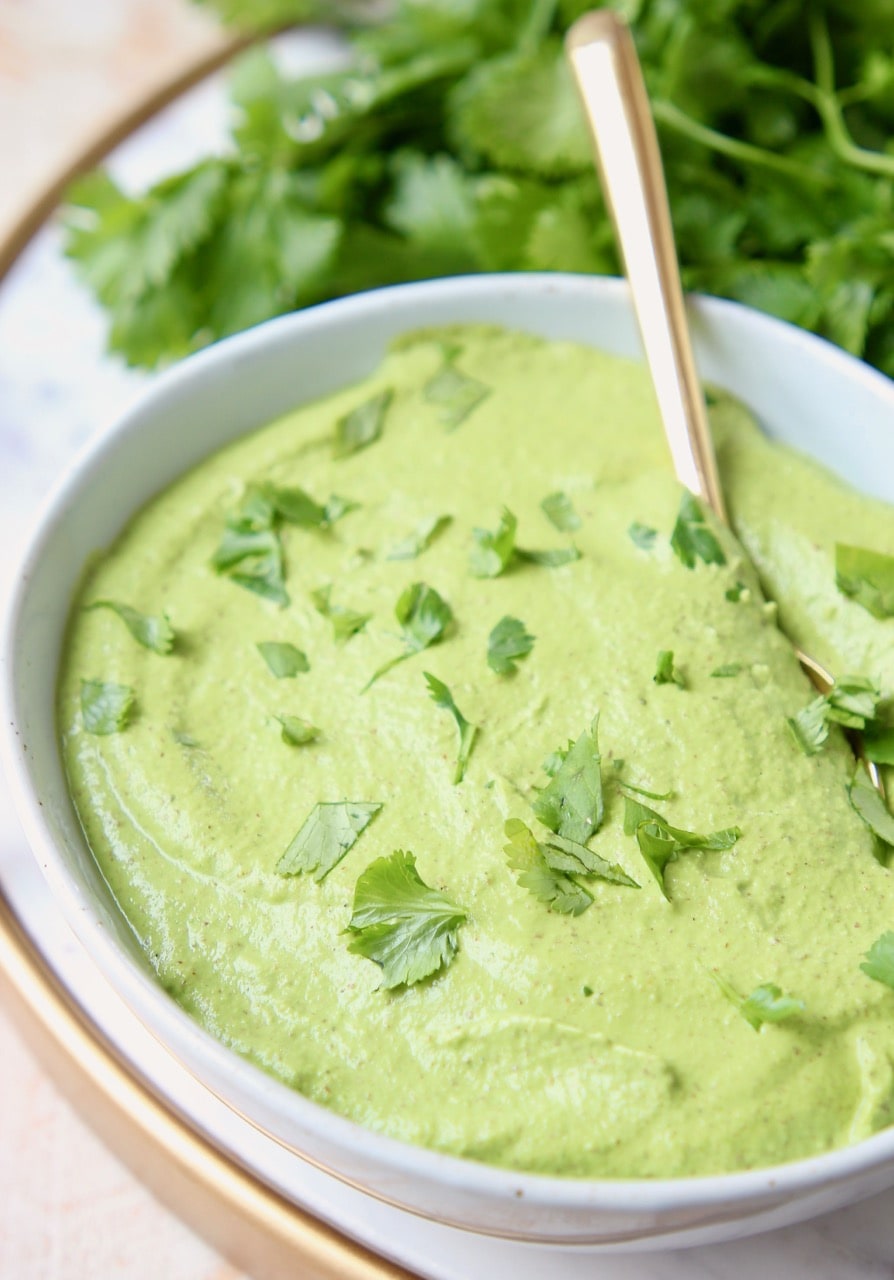 Cilantro lime pesto in bowl with gold spoon