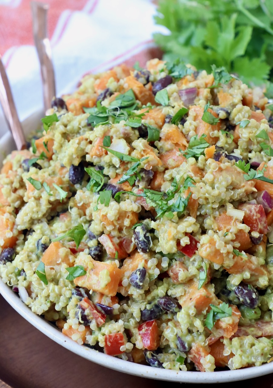 sweet potato salad with quinoa and black beans in bowl with forks