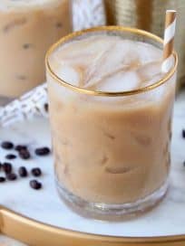 Long Island drink with coffee in glasses with gold and white striped straws