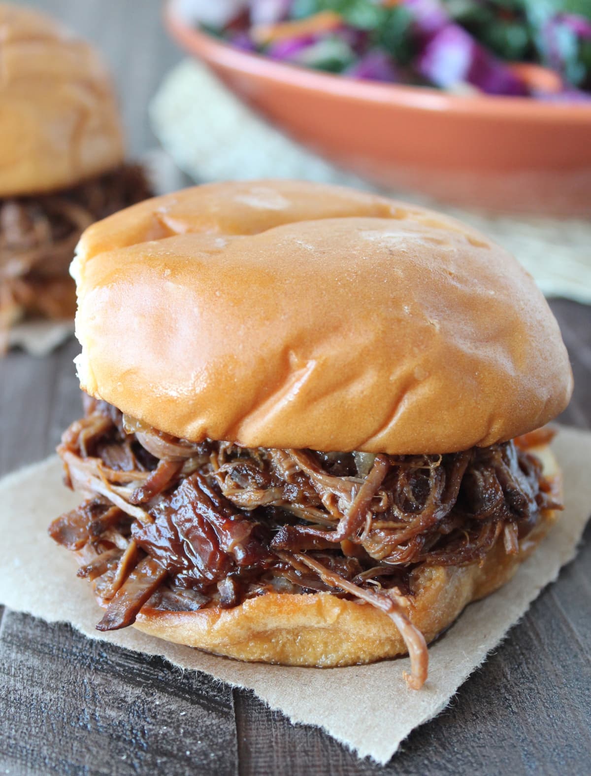 shredded bbq brisket in between two hamburger buns