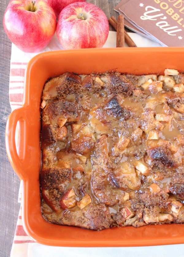 baked bread pudding topped with caramel sauce in orange baking dish
