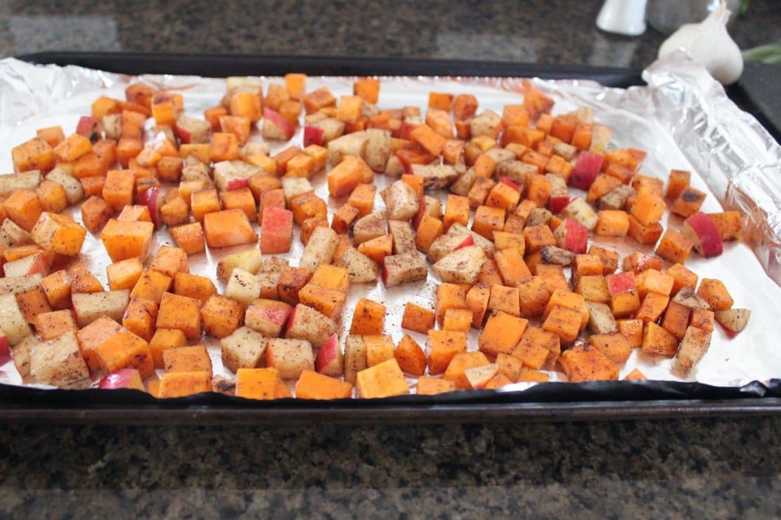 seasoned diced butternut squash and apples on foil-lined baking sheet