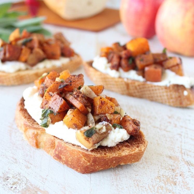 Diced Roasted Butternut Squash and apples on top of ricotta cheese on toasted slices of bread