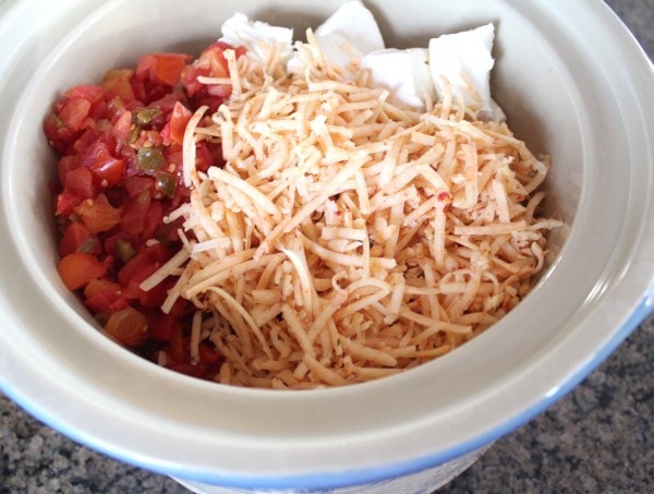 cheese and canned diced tomatoes with green chilies in slow cooker