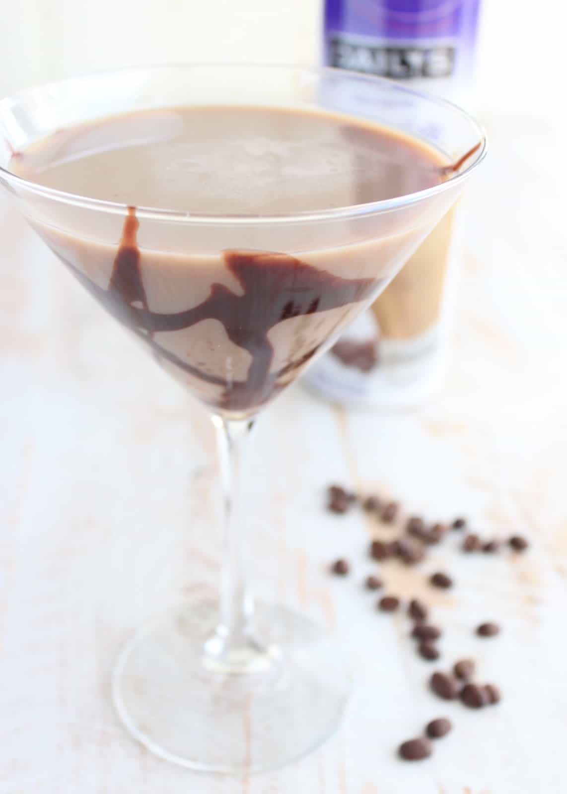 mocha martini in a martini glass with chocolate syrup