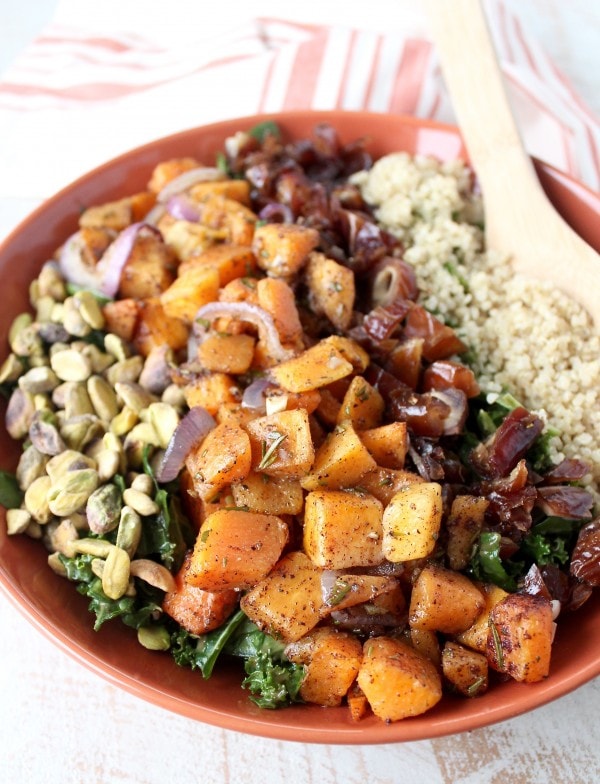 salad in bowl with diced roasted butternut squash, pistachios and chopped dates