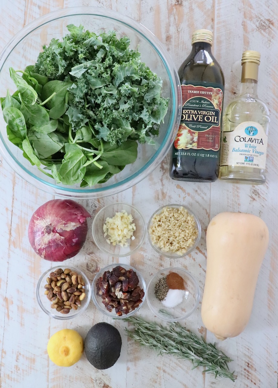 butternut squash salad ingredients laid out on  a white wood board 