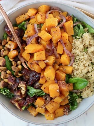 butternut squash salad in a bowl with a fork