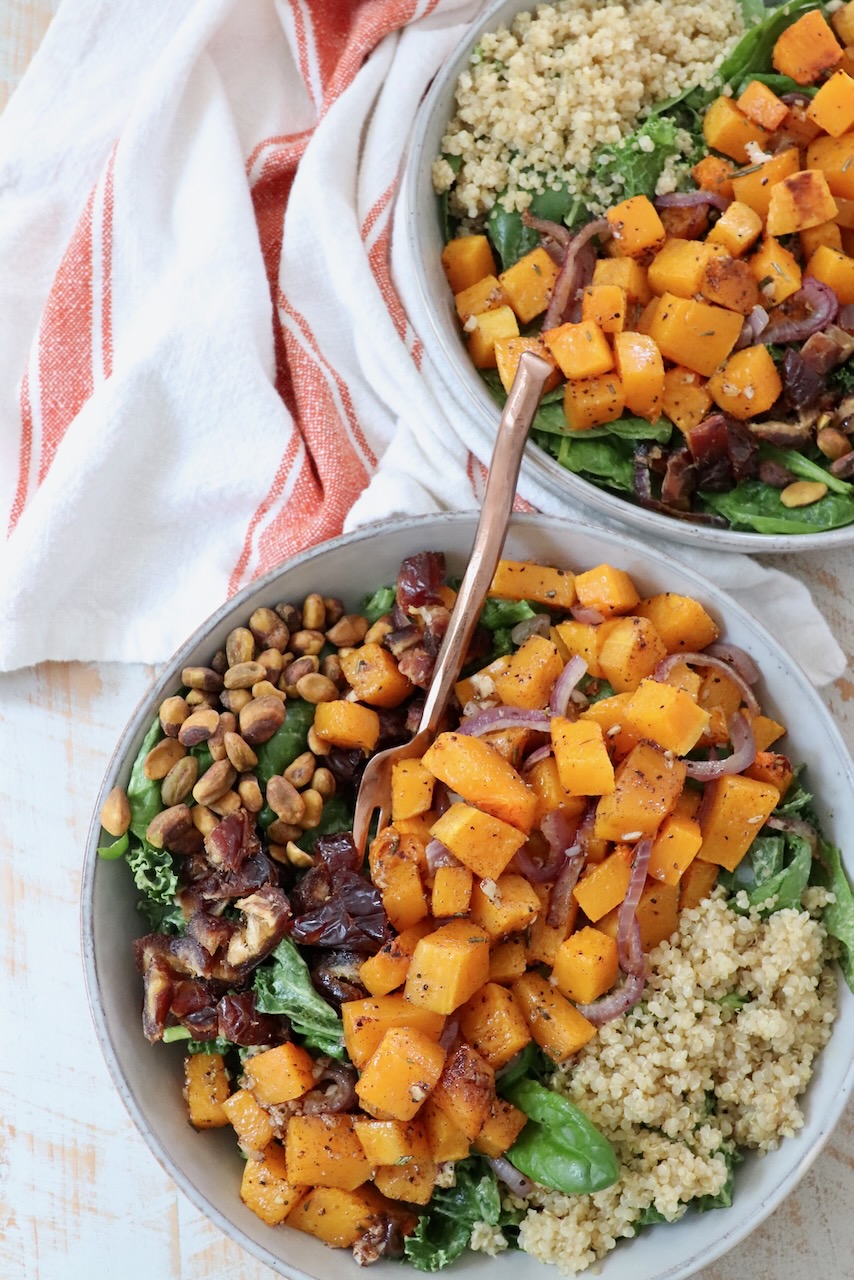 butternut squash salad in two bowls with forks