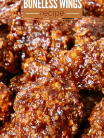 cooked chicken crispers tossed in sauce on a plate