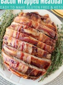 Sliced cooked bacon wrapped meatloaf on plate