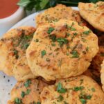 cheddar biscuits stacked up on a plate