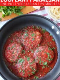 Overhead image of eggplant parmesan in skillet with sauce