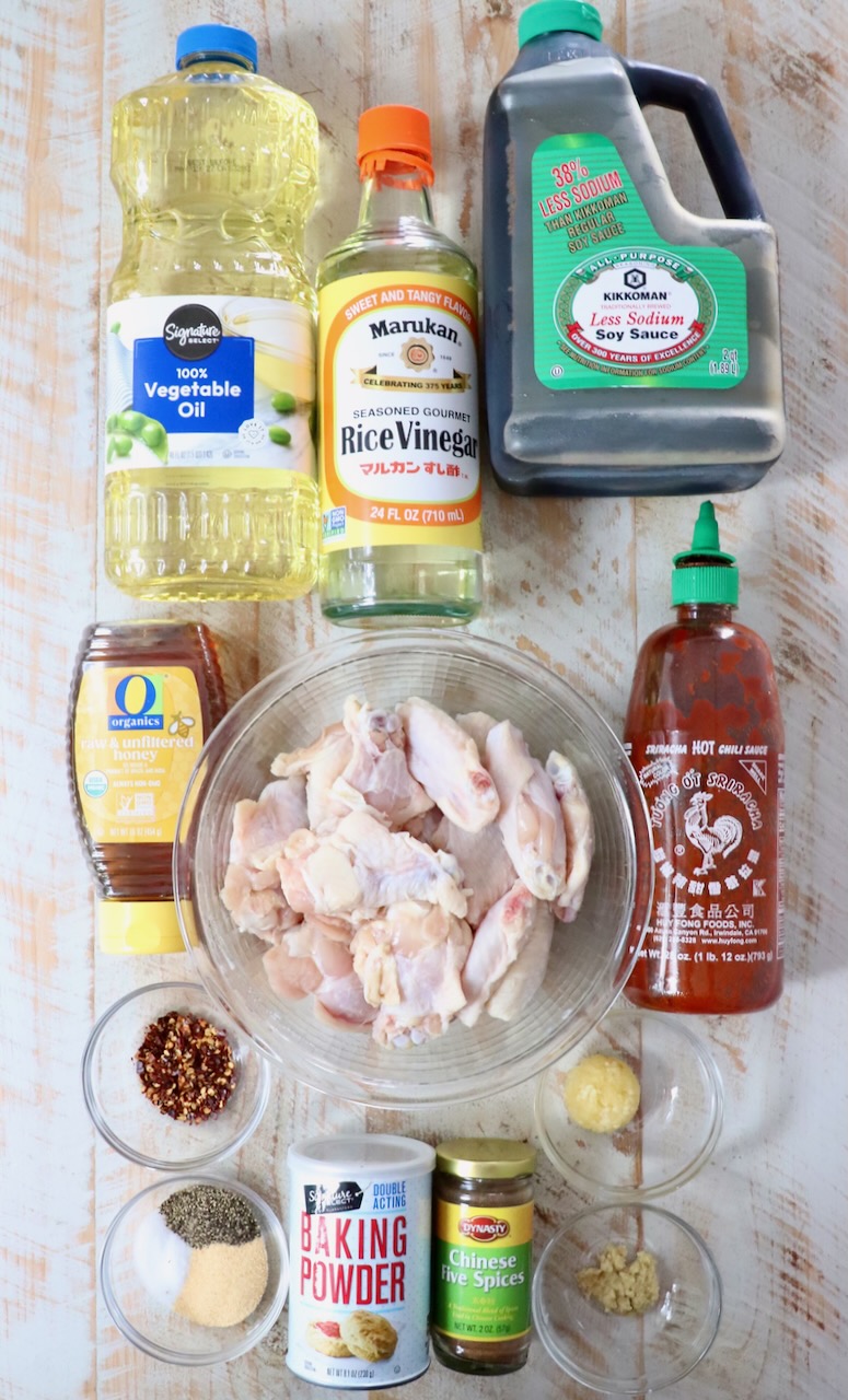 ingredients for general tso chicken wings on a white wood board