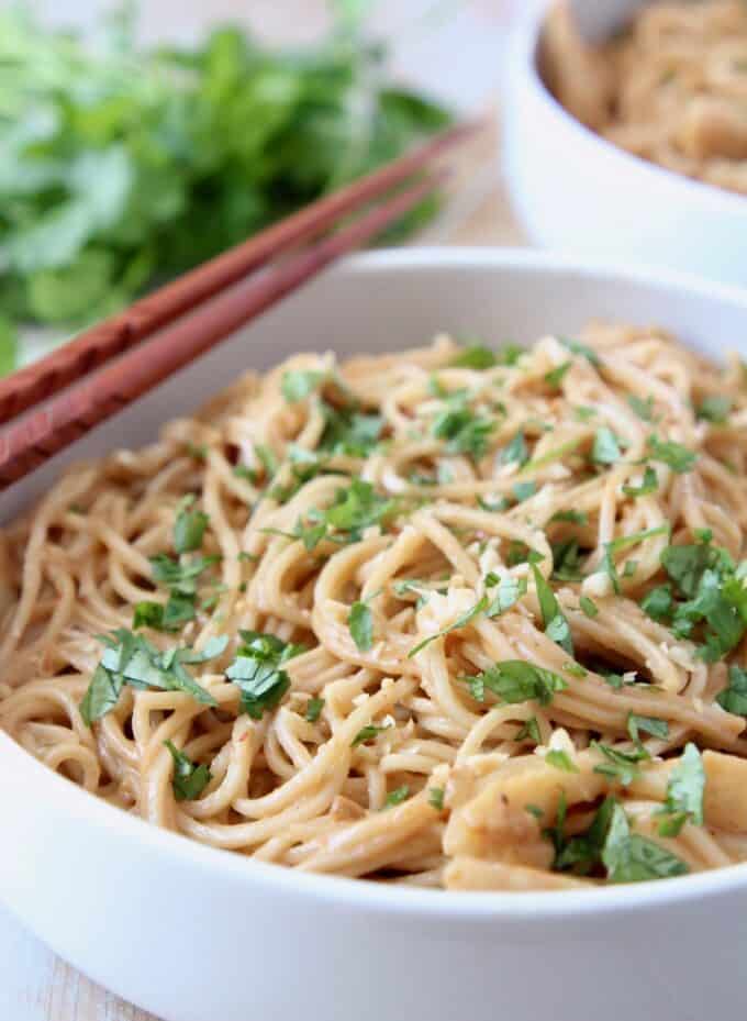 noodles in bowl topped with chopped fresh cilantro