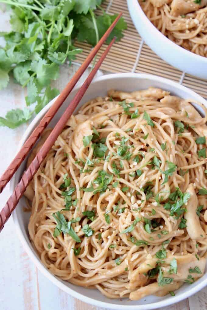 overhead image of noodles in bowl with chopsticks on the side