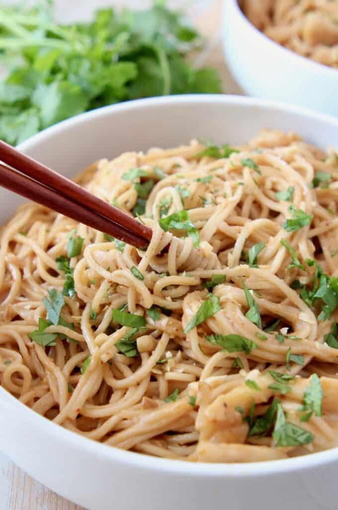 chopsticks swirling noodles in bowl