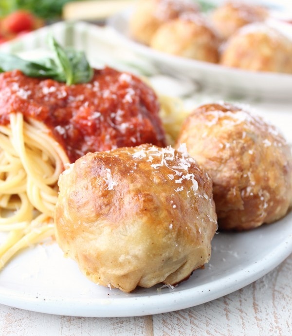 Puff Pastry Wrapped Meatballs on plate with spaghetti and marinara sauce